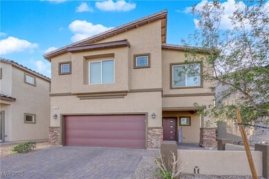 View of front of house with stucco siding, stone s