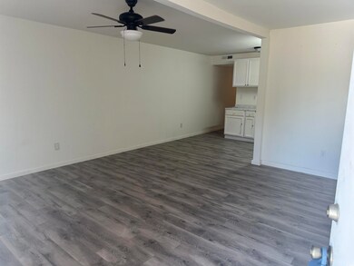 Spare room featuring ceiling fan and hardwood / wo