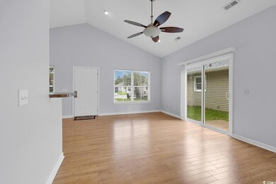 Unfurnished room with ceiling fan, light wood-style floors, and high vaulted ceiling