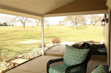 Relax on the porch overlooking the 1.3 acres!