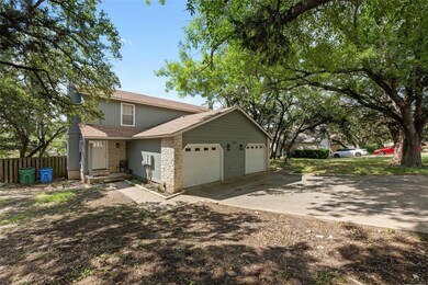 View of front of property featuring a shingled roof, fence, concrete driveway, a garage, and stone siding