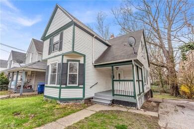 View of front of house with roof with shingles, a porch, and fence