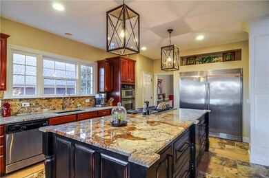 Another view of the stunning kitchen- granite countertops, designer faucet and plenty of counter and cabinet space! 