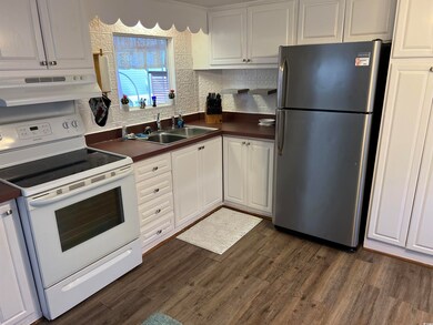 Kitchen featuring sink, white cabinets, stainless 