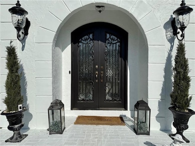 View of exterior entry featuring french doors
