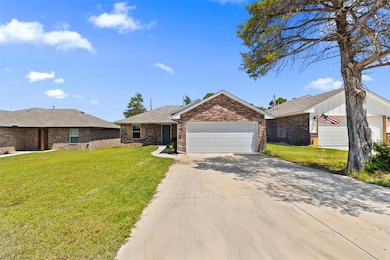 Single story home with an attached garage, a front