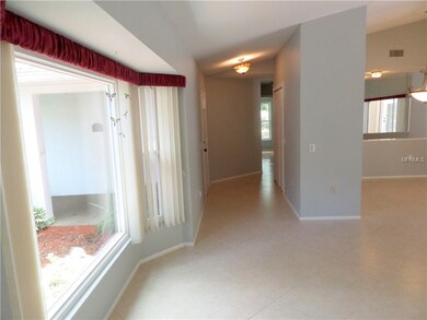 Wide bay window and view to entry foyer. NOTE: ent