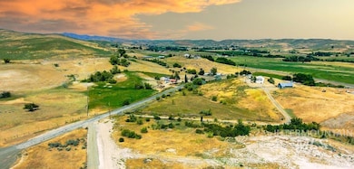 Aerial view of property's location featuring rural landscape and mountains