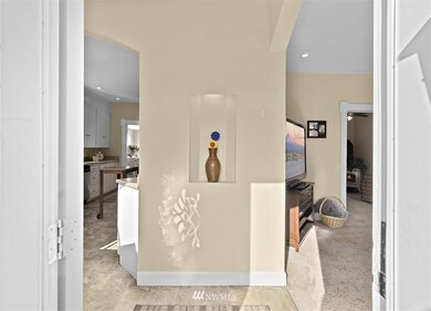 Beautiful entryway with recessed art alcove to show off your favorite artwork! Notice the flair that the archways to the kitchen and living room provide.