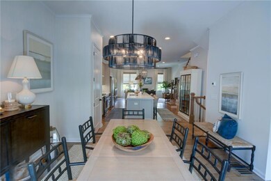 Dining area with baseboards, recessed lighting, a notable chandelier, wood finished floors, and crown molding