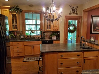 Rich hickory cabinets, chandelier accent.