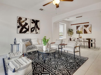 The open-concept layout connects the living and dining spaces seamlessly, creating an airy, conversational flow that feels both stylish and grounded.