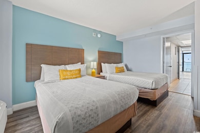 Bedroom featuring wood finished floors and baseboards
