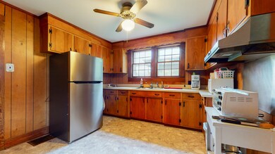 Kitchen has lots of room to add more cabinets or have a small kitchen table for a breakfast nook.