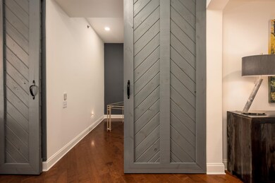 Hall with recessed lighting, wood finished floors,