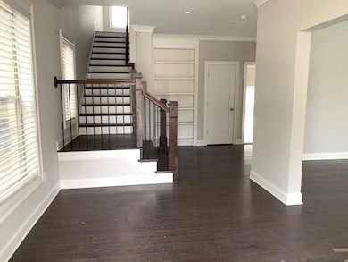 Staircase with wood finished floors, baseboards, b
