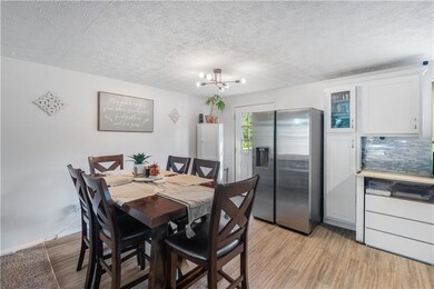 Dining room featuring a textured ceiling, light wo