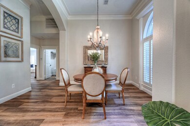 Formal dining area with chic wooden chandelier adj