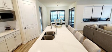 Dining area with sink, light hardwood / wood-style