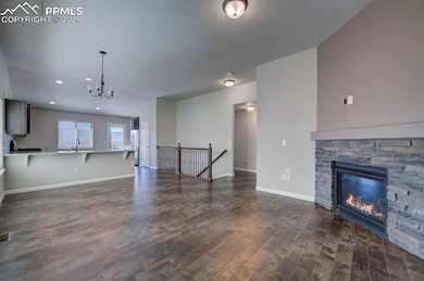 Unfurnished living room with a stone fireplace, si