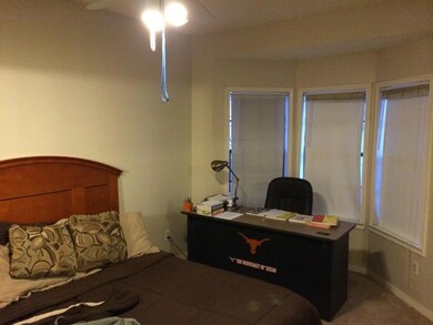Bedroom featuring a ceiling fan and an office area