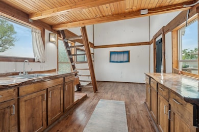 Kitchen with a sink, wooden ceiling with exposed 