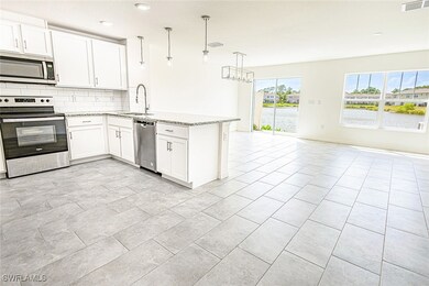 Kitchen featuring open floor plan, a peninsula, ba