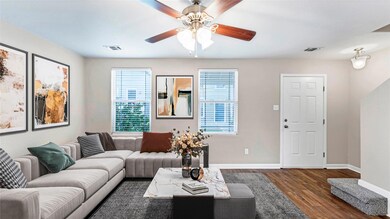 Living area with baseboards, dark wood-type floor