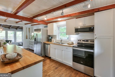 The kitchen is a bright, open-concept space filled
