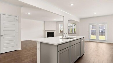 Kitchen featuring a sink, dishwasher, gray cabinet