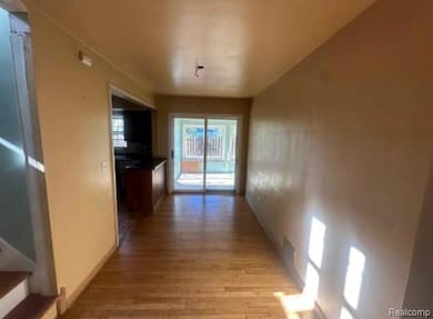 Hall featuring light wood finished floors