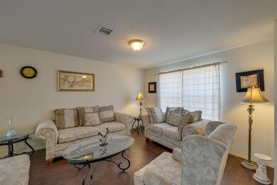 The formal living area with plenty of natural ligh