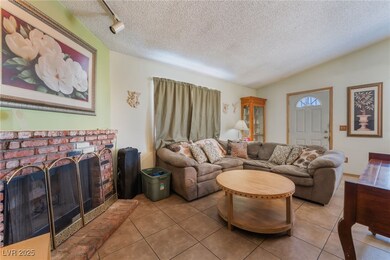 Living room featuring tile patterned floors, a tex