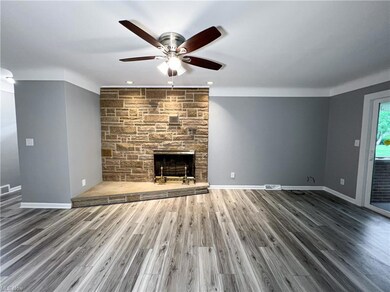 Hardwood floored living room featuring a fireplace