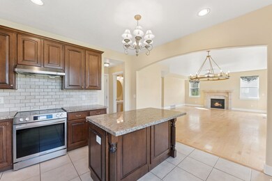 Kitchen featuring stainless steel electric stove, decorative light fixtures, a chandelier, and recessed lighting