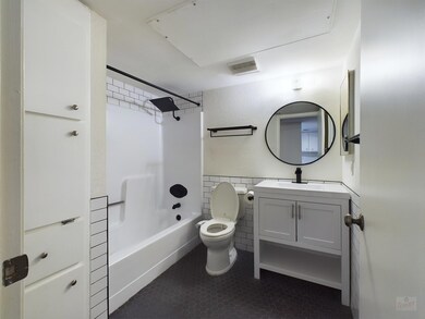 Bathroom featuring toilet, vanity, tub / shower c
