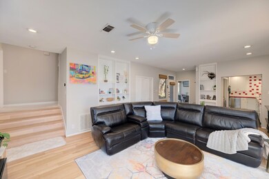 Living area with a ceiling fan, wood finished flo