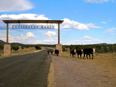 Crossroads Ranch arch with cows