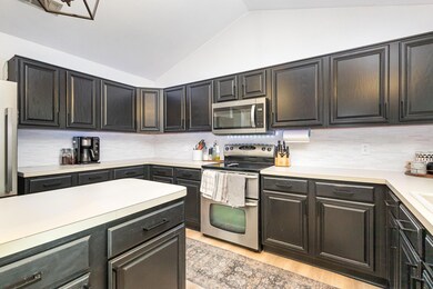 Kitchen with decorative backsplash, light wood-sty