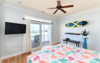 Bedroom featuring ornamental molding, light wood-style flooring, access to outside, and ceiling fan