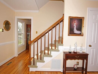 Greet your guests in the foyer featuring hardwood 