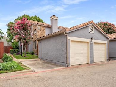 Mediterranean / spanish-style home featuring a chimney, a tiled roof, stucco siding, and an attached garage