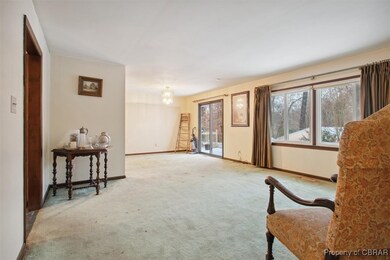 Sitting room featuring light carpet