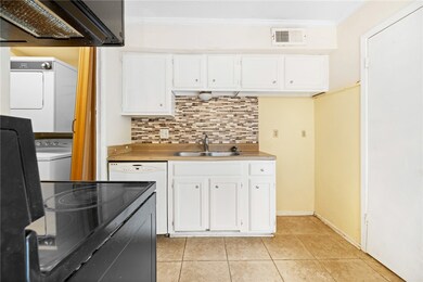 Kitchen featuring extractor fan, stacked washing m
