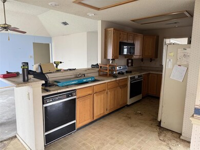 Kitchen featuring black appliances, sink, ceiling 