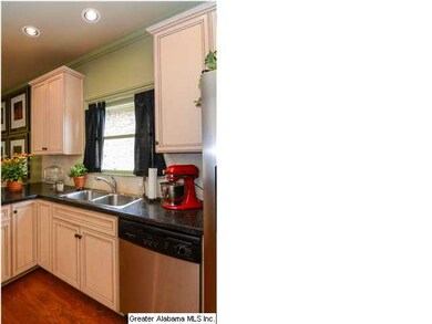 Hardwood Floors and Natural light keep this kitche