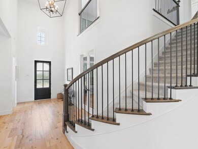 Entryway with high ceilings, a Designer Chandelier