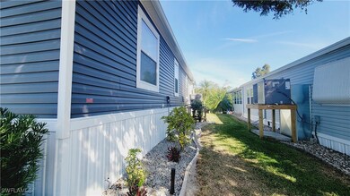 View of side of property featuring a lawn