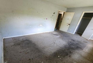 Unfurnished bedroom with carpet floors, baseboards, and a closet