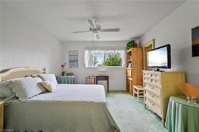 Carpeted bedroom featuring ceiling fan